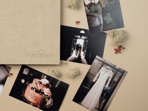 Beige Leather Photo Album with printed photographs next to it.