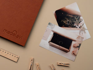 Brown Leather Photo Album with printed photographs next to it.