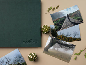 Lush Green Leather Photo Album with printed photographs next to it.