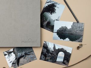 Grey Leather Photo Album with printed photographs next to it.