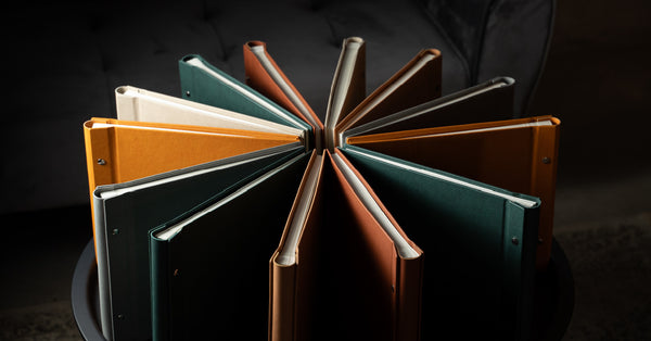 Madelavi photo album set in various colors arranged in a circle on a dark background.